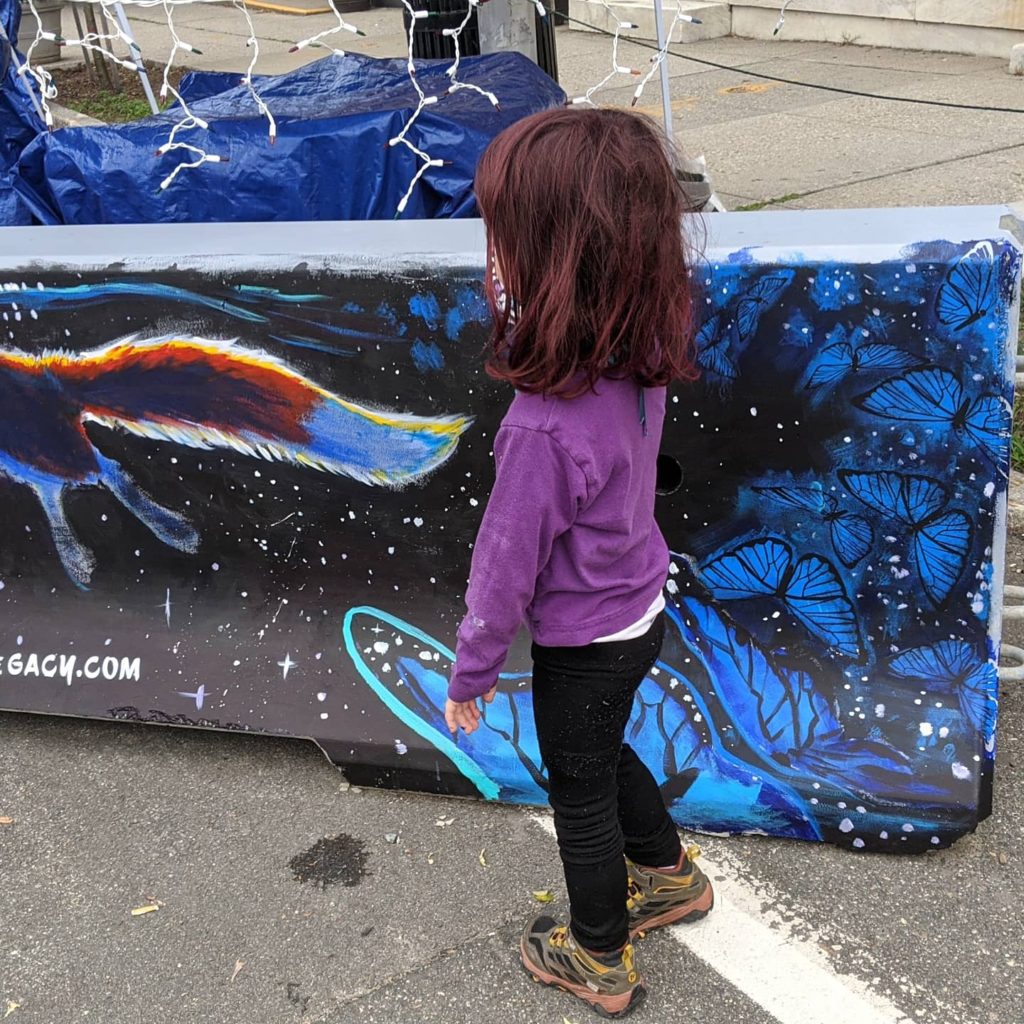child looking at mural