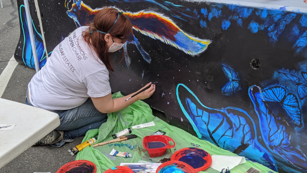 artist putting final touches on barrier